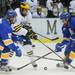 Michigan freshman Andrew Sinelli battles Lake Superior State senior Kyle Haines and freshman Buddy Robinson for the puck in the second period at Yost Arena on Friday night. Melanie Maxwell I AnnArbor.com